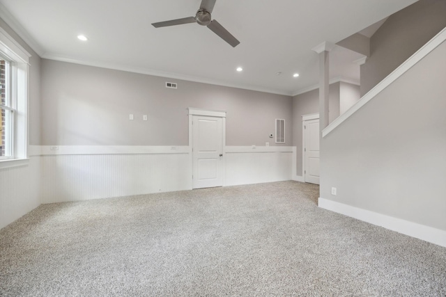 spare room with crown molding, ceiling fan, and carpet