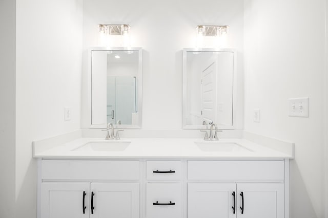 bathroom with vanity and a shower with shower door