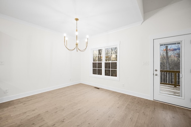 unfurnished dining area with an inviting chandelier, crown molding, and wood-type flooring