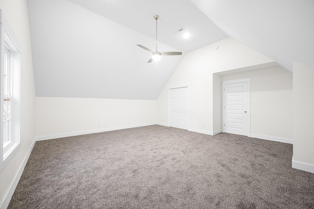 additional living space featuring ceiling fan, lofted ceiling, and dark carpet