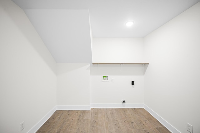 clothes washing area with light hardwood / wood-style floors, hookup for a washing machine, and electric dryer hookup