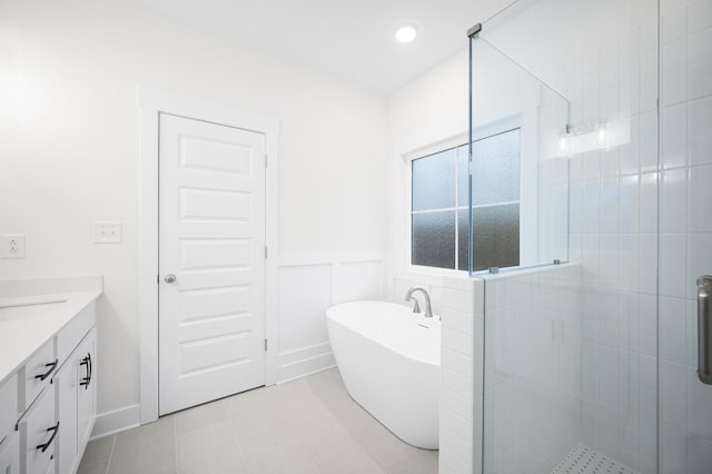 bathroom featuring vanity, tile patterned flooring, and shower with separate bathtub