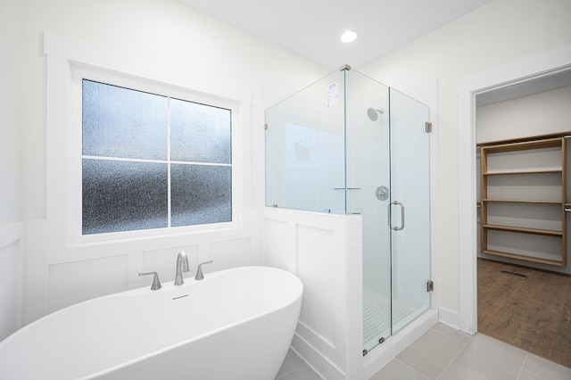 bathroom featuring tile patterned flooring and plus walk in shower