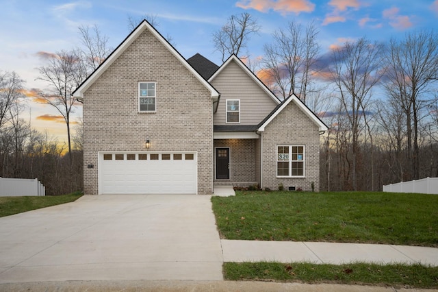 view of front of house featuring a garage and a lawn