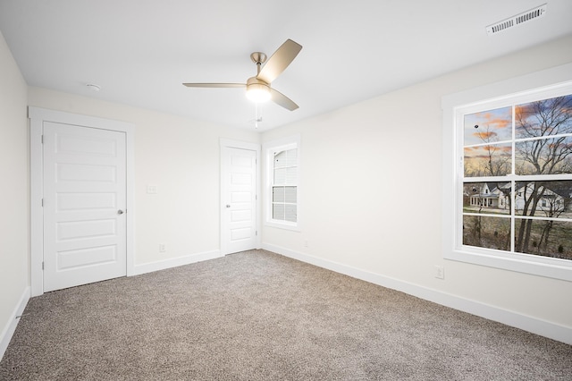 carpeted empty room with ceiling fan