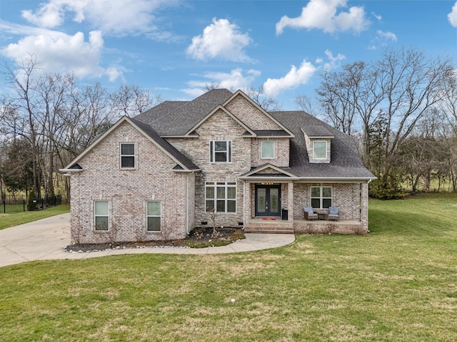 craftsman house with a porch and a front lawn