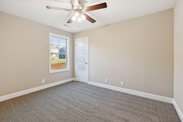 carpeted spare room with ceiling fan