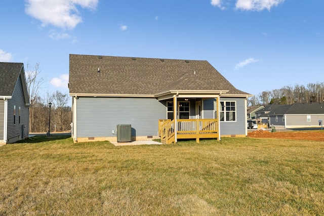 rear view of property with a yard, central air condition unit, and a deck