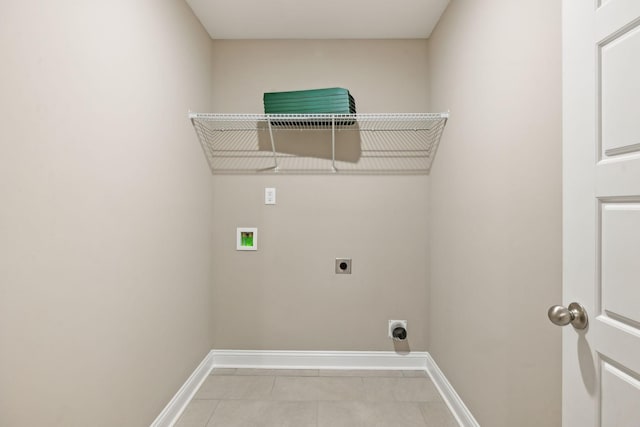 clothes washing area with hookup for a washing machine, electric dryer hookup, and light tile patterned floors