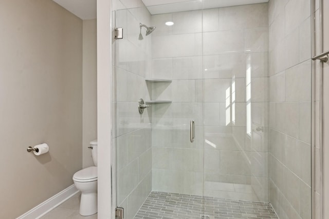 bathroom with tile patterned flooring, walk in shower, and toilet