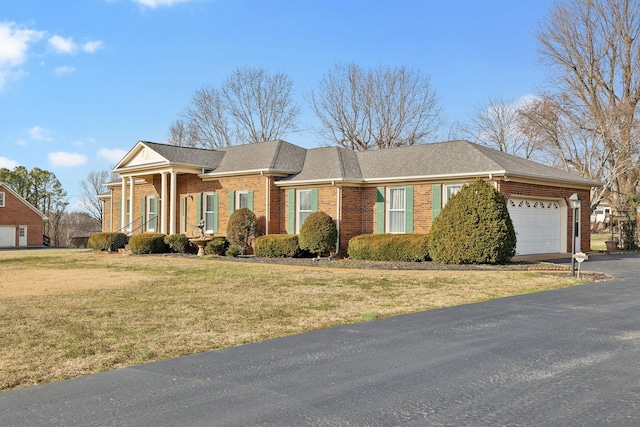 ranch-style house featuring a garage and a front yard