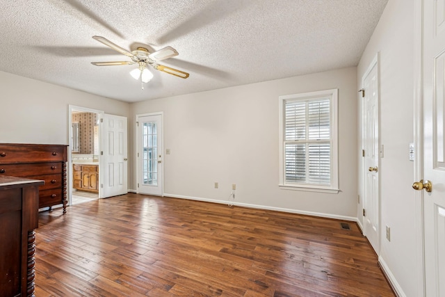 entryway with dark hardwood / wood-style flooring, a textured ceiling, plenty of natural light, and ceiling fan