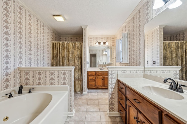 bathroom with a tub, vanity, crown molding, tile patterned floors, and a textured ceiling