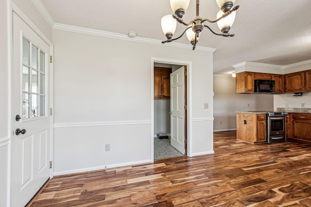 kitchen featuring stainless steel range with electric stovetop, crown molding, dark wood-type flooring, and a chandelier