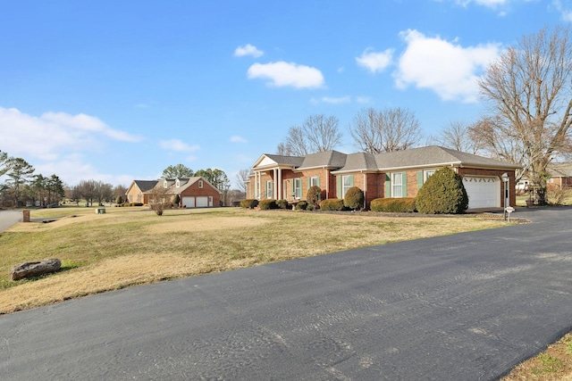 single story home with a garage and a front yard