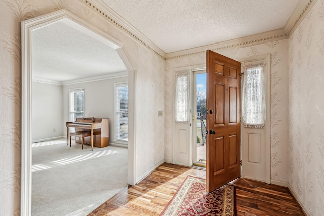 entrance foyer with hardwood / wood-style floors and a textured ceiling