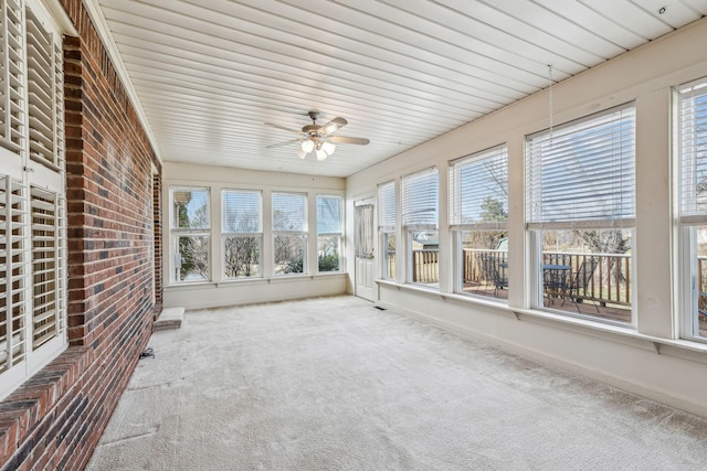 unfurnished sunroom with ceiling fan