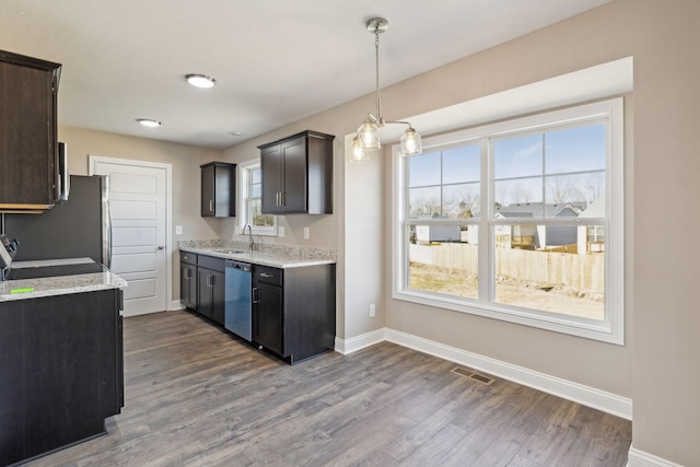 kitchen featuring light stone counters, dark brown cabinets, dishwasher, and range