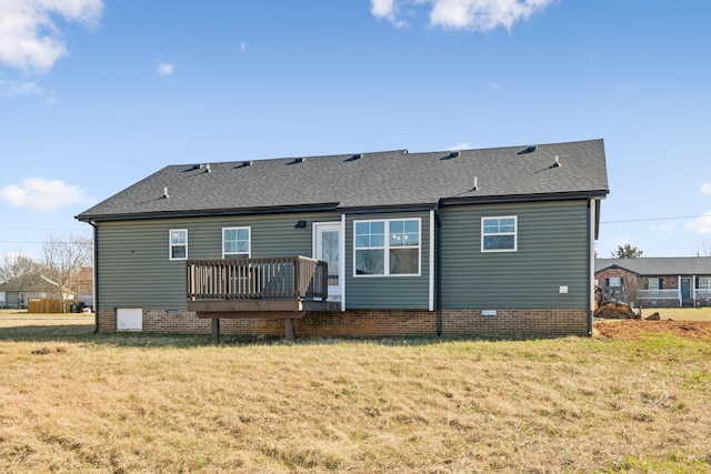 rear view of property with a yard and a deck