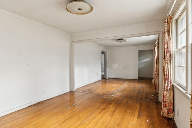 unfurnished room featuring wood-type flooring and ornamental molding