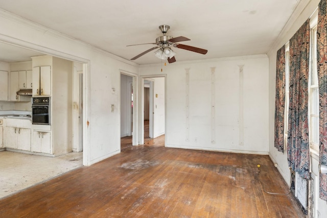 unfurnished living room with crown molding, dark wood-type flooring, and ceiling fan