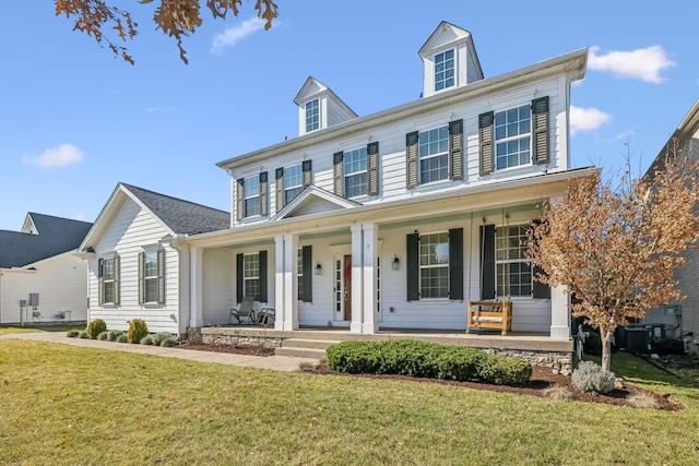 view of front of property featuring covered porch and a front lawn