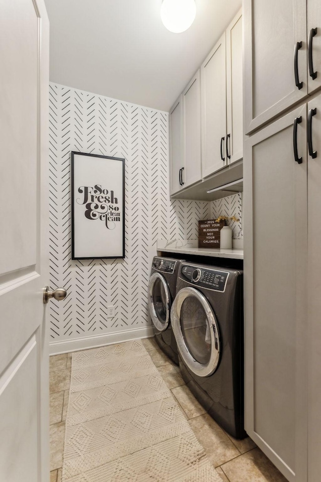 laundry room with cabinets and separate washer and dryer