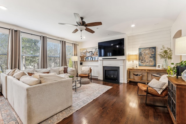 living room with ceiling fan and dark hardwood / wood-style floors