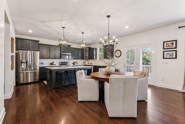 dining room featuring a notable chandelier and dark hardwood / wood-style flooring