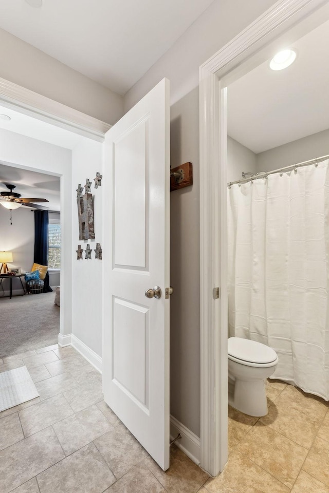 bathroom with ceiling fan and toilet