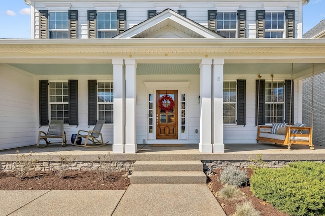 property entrance with covered porch