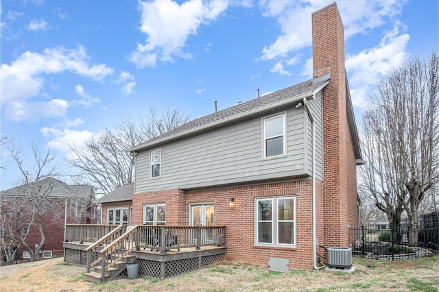 back of property featuring a lawn, central air condition unit, and a deck