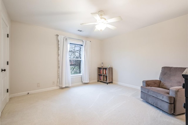 sitting room featuring light colored carpet and ceiling fan