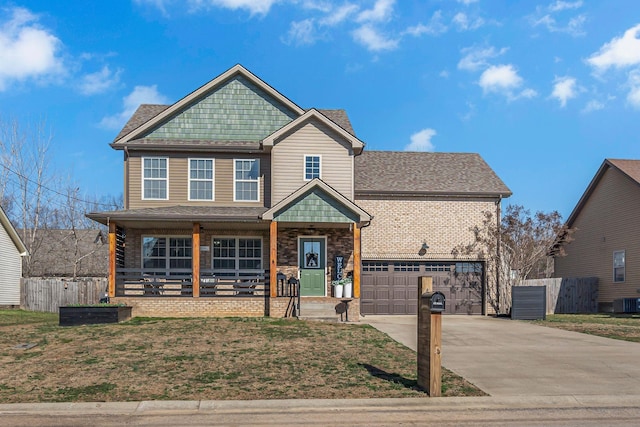 view of front of property with cooling unit, a garage, and a porch