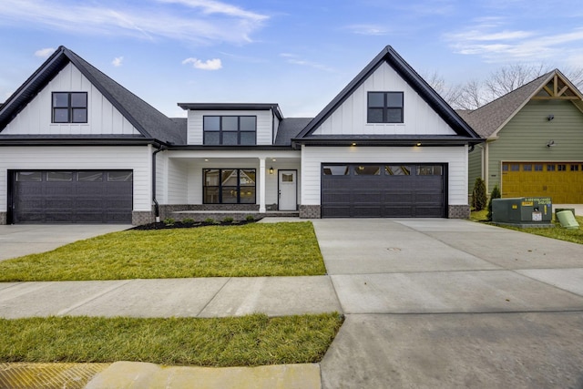 modern farmhouse style home featuring a garage and a front lawn