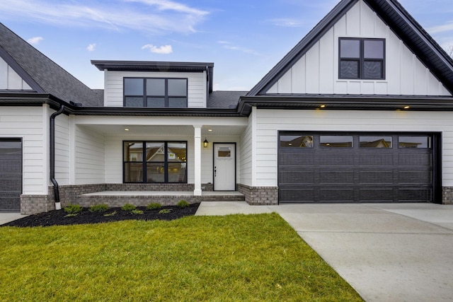 modern farmhouse featuring a garage and a front yard