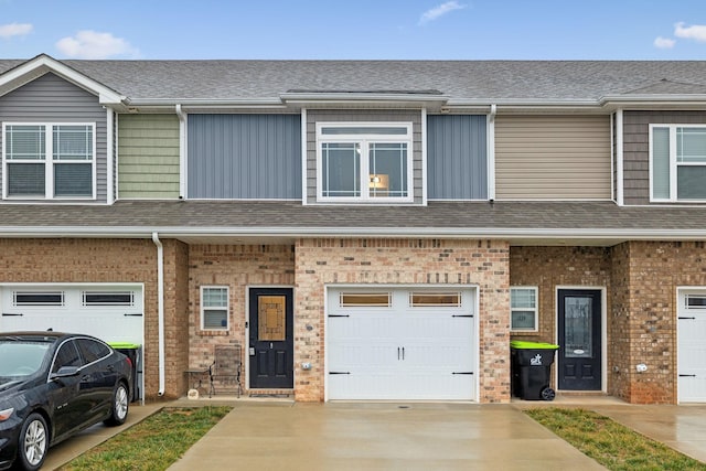 townhome / multi-family property featuring a garage