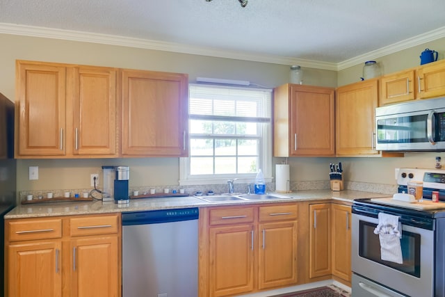 kitchen featuring ornamental molding, appliances with stainless steel finishes, and sink