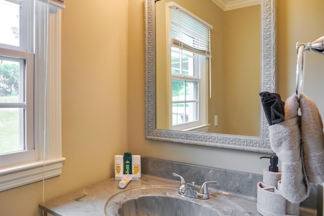 bathroom with ornamental molding and vanity