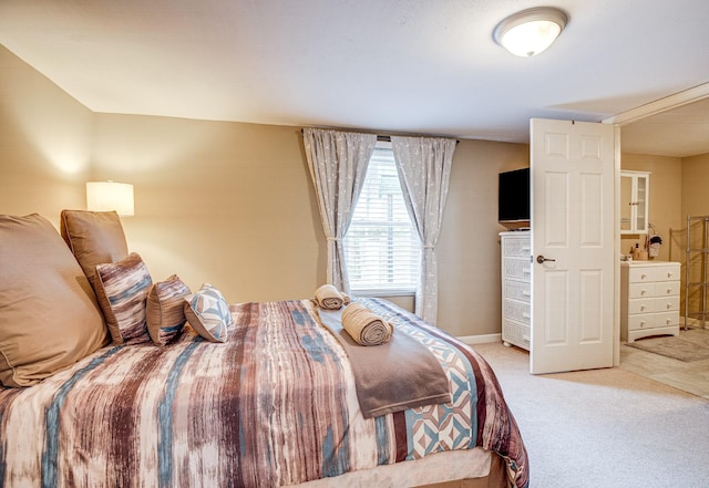 bedroom featuring light carpet