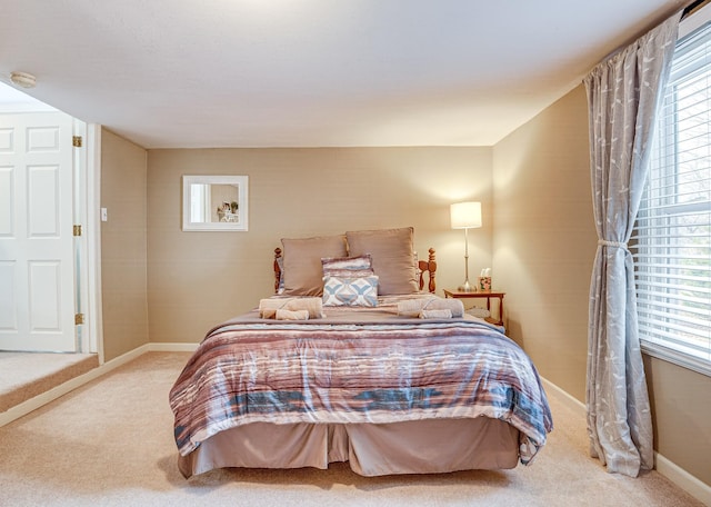 carpeted bedroom featuring multiple windows