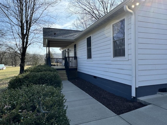 view of side of property with covered porch