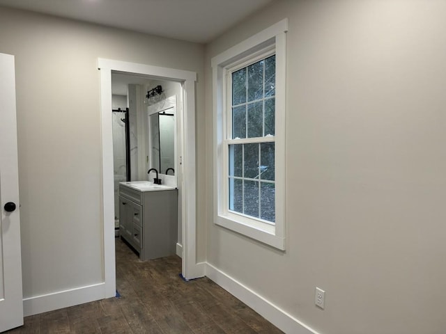 hall with dark hardwood / wood-style flooring and sink