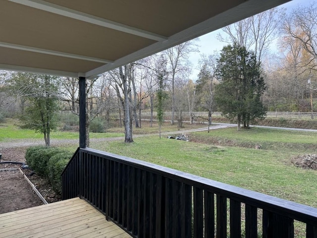 wooden terrace with a lawn