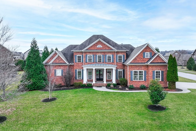 view of front of home with a front lawn and brick siding