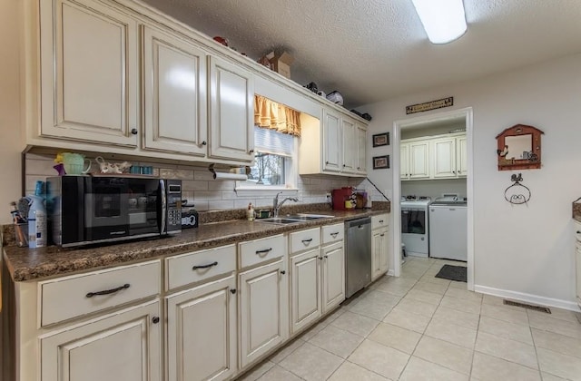 kitchen with light tile patterned flooring, washing machine and clothes dryer, sink, tasteful backsplash, and dishwasher