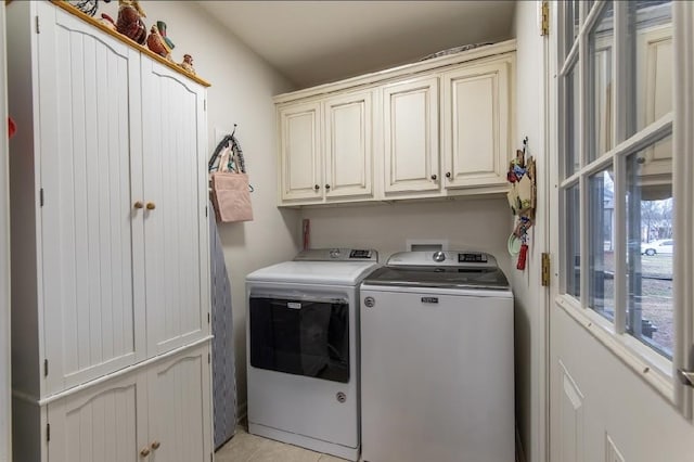 laundry room featuring cabinets and washing machine and dryer