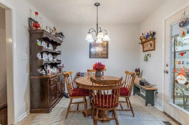 dining room featuring light tile patterned floors and a chandelier