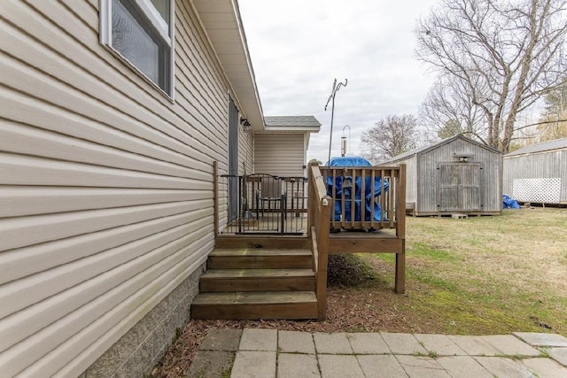 wooden terrace featuring a lawn and a storage unit