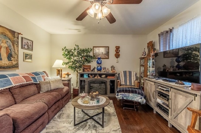 living room with ceiling fan and dark hardwood / wood-style flooring